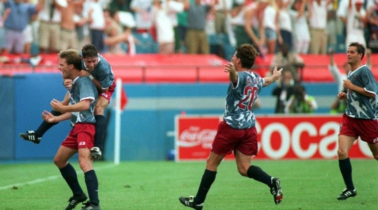 ERIC WYNLANDA IS HUGGED BY TAB RAMOS AFTER SCORING A GOAL ON A PENALTY KICK AGAINST SWITZERLAND AT THE SILVERDOME IN PONTIAC, MICHIGAN. AT RIGHT, USA TEAM MEMBERS PAUL CALIGIURI AND JOHN HARKES RUN TO JOIN THE CELEBRATION. THE GAME END