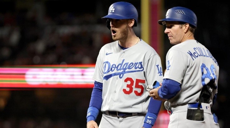 Cody Bellinger #35 of the Los Angeles Dodgers celebrates with first base coach Clayton McCullough #86 his RBI single (Photo by Harry How/Getty Images)