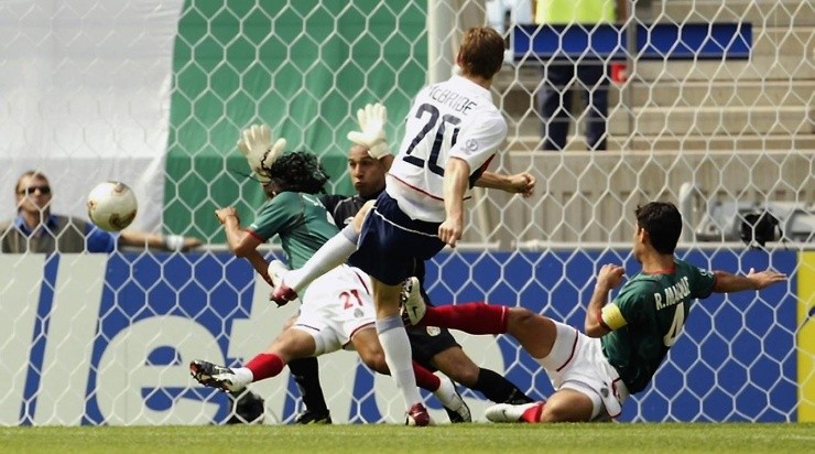 Brian McBride of the USA shoots past (L to R) Jesus Arellano, Oscar Perez and Rafael Marquez during the Mexico v USA, World Cup Second Round match played at the Jeonju World Cup Stadium, Jeonju, South Korea on June 17, 2002. The USA won 2-0. (Photo by Brian Bahr/Getty Images)