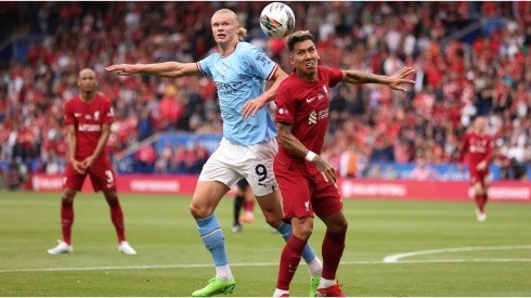 Erling Haaland of Manchester City in action with Roberto Firmino of Liverpool