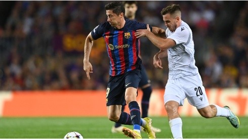Robert Lewandowski of FC Barcelona battles for possession with Pavel Bucha of Viktoria Plzen