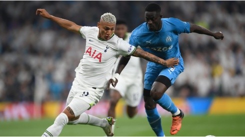 Richarlison of Tottenham Hotspur battles for possession with Eric Bailly of Marseille