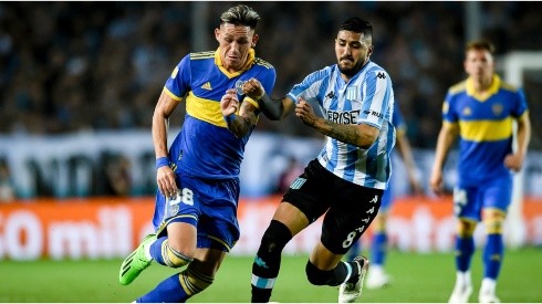 Luis Vazquez of Boca Juniors fights for the ball with Jonathan Galvan of Racing Club