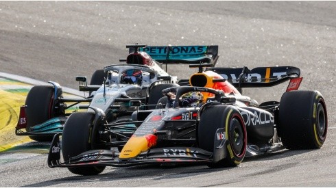 George Russell of Mercedes attacks Max Verstappen of Red Bull Racing