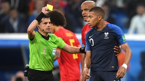 Mbappe receiving a yellow card in Russia 2018.