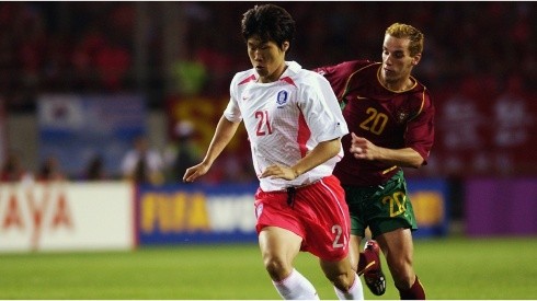 Ji Sung Park of South Korea holds off Petit of Portugal