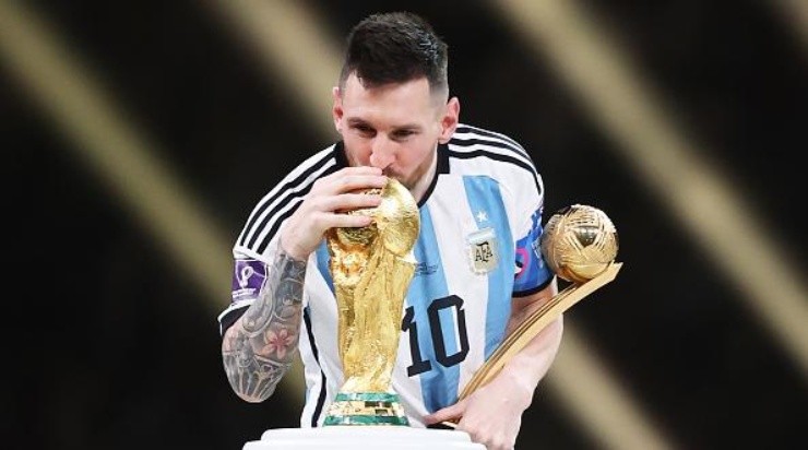 LUSAIL CITY, QATAR - DECEMBER 18: Lionel Messi of Argentina kisses the FIFA World Cup Qatar 2022 Winners&#039; Trophy while holding the adidas Golden Boot award after the FIFA World Cup Qatar 2022 Final match between Argentina and France at Lusail Stadium on December 18, 2022 in Lusail City, Qatar. (Photo by Julian Finney/Getty Images)