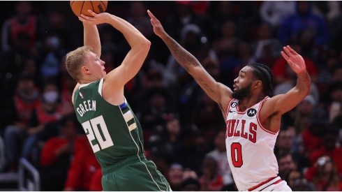 AJ Green of the Milwaukee Bucks shoots over Coby White of the Chicago Bulls