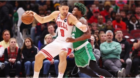 Nikola Vucevic of the Chicago Bulls drives to the basket against Marcus Smart of the Boston Celtics
