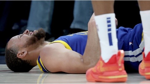 Stephen Curry #30 of the Golden State Warriors is knocked to the floor