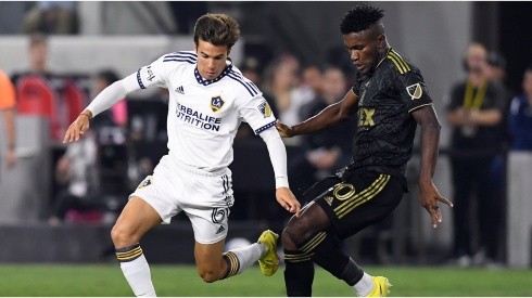 Riqui Puig #6 of Los Angeles Galaxy controls the ball against Jose Cifuentes #20 of Los Angeles FC