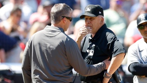 Umpire Larry Vanover being checked out by a trainer after getting hit in the Yankees-Guardians game.