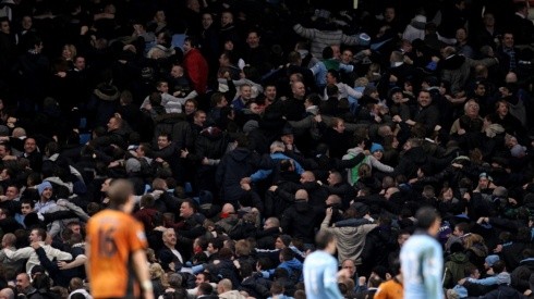 Manchester City fans turn their back on the pitch following a goal.