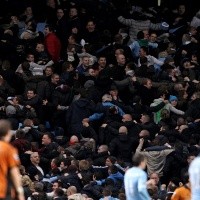 Why do Manchester City fans turn their backs when they celebrate goals?