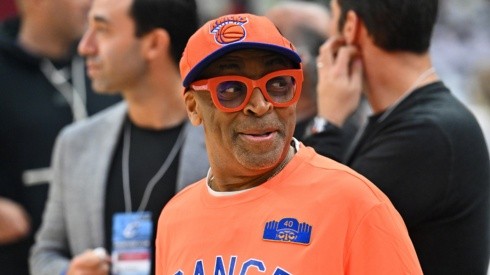 New York Knicks fan Spike Lee talks with other fans prior to a game.
