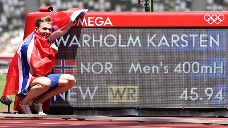 Karsten Warholm of Team Norway poses with a scoreboard showing his new world record time after winning the gold medal in the Men's 400m Hurdles Final on day eleven of the Tokyo 2020 Olympic Games at Olympic Stadium on August 03, 2021 in Tokyo, Japan. (Photo by Ryan Pierse/Getty Images