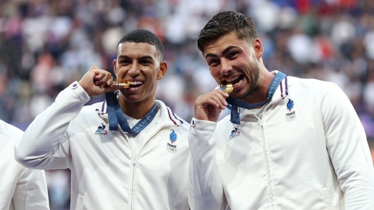 Antoine Zeghdar and Jefferson-Lee Joseph of Team France line up after collecting their gold medals on the podium following the team’s victory in the Men’s Rugby Sevens Gold Medal match between France and Fiji on day one of the Olympic Games Paris 2024 at Stade de France on July 27, 2024 in Paris, France. (Photo by Cameron Spencer/Getty Images)
