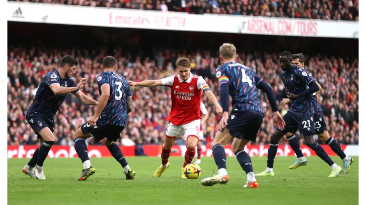 LONDON, ENGLAND – OCTOBER 30: Martin Odegaard is surrounded by Nottingham Forest players before scoring his sides fifth goal during the Premier League match between Arsenal FC and Nottingham Forest at Emirates Stadium on October 30, 2022 in London, England. (Photo by Alex Pantling/Getty Images)
