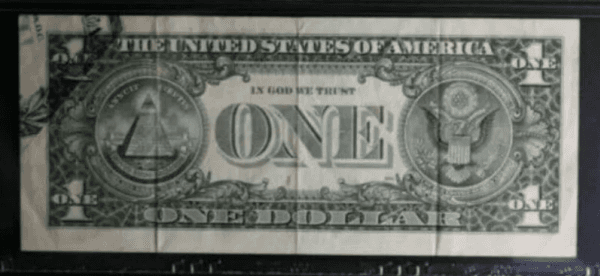 El error de impresión en la parte superior izquierda del dorso del billete de 1 dólar.