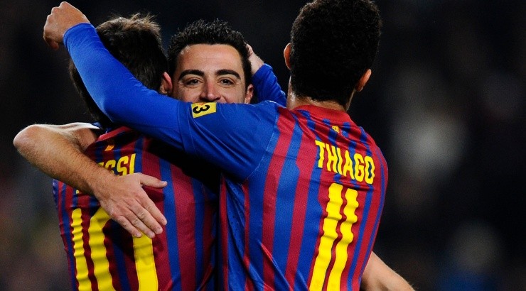 Xavi (center), Lionel Messi (left) and Thiago Alcantara (right). (David Ramos/Getty Images)