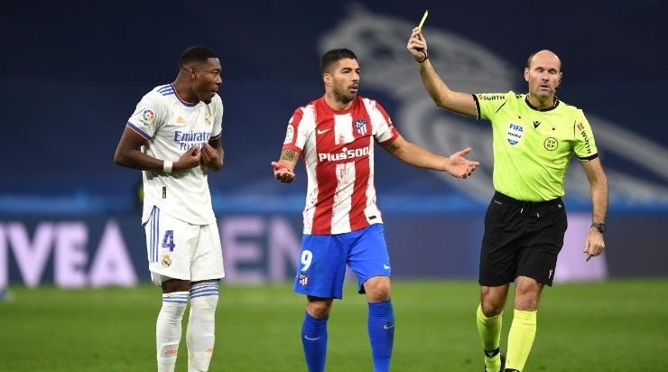 Luis Suarez of Atletico de Madrid and David Alaba of Real Madrid CF receive yellow cards (Photo by Denis Doyle/Getty Images)