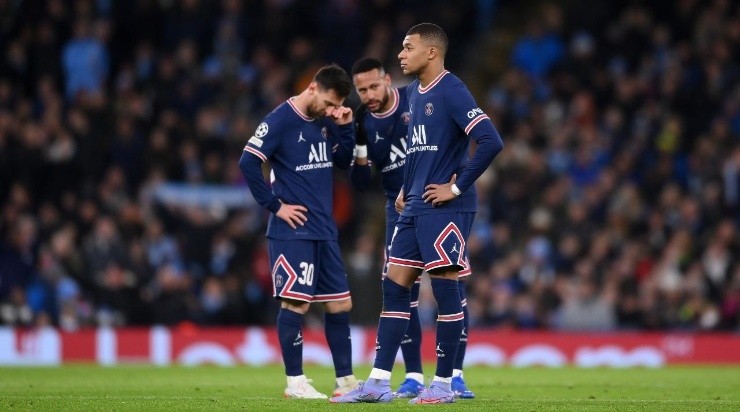 Kylian Mbappe of Paris Saint-Germain reacts as teammates Lionel Messi and Neymar talk in the background (Photo by Laurence Griffiths/Getty Images)