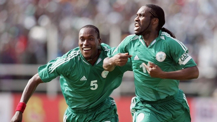 Jay-Jay Okocha (right) of Nigeria celebrates his goal with Chidi Odiah during the 2006 World Cup Qualifying match against Angola (Getty).