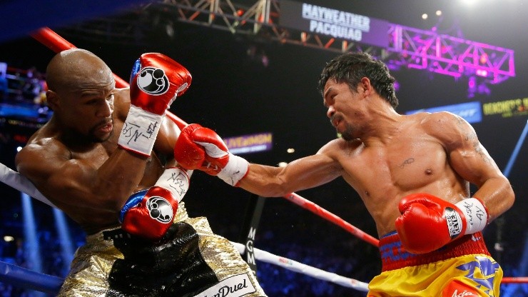 Manny Pacquiao throws a right at Floyd Mayweather Jr. during their welterweight unification championship bout (Getty)