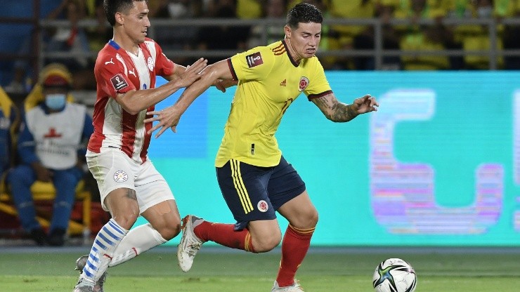 James Rodriguez of Colombia and Matias Rojas of Paraguay fight for the ball.