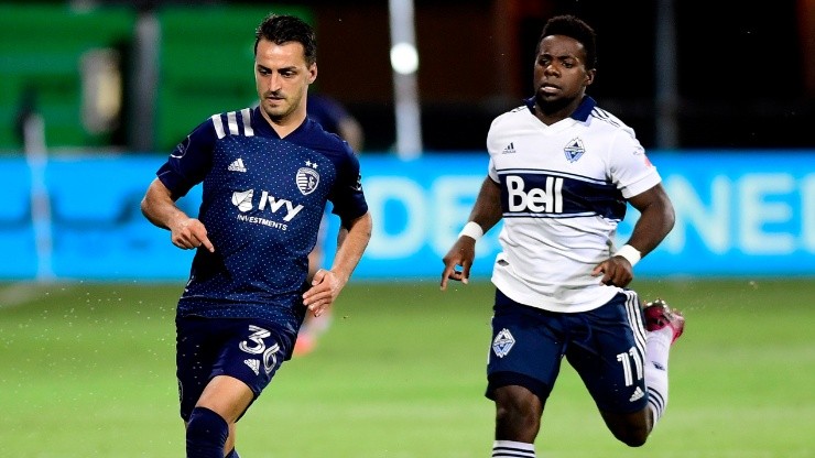 Luis Martins of Sporting Kansas City (left) against Cristian Dajome of Vancouver Whitecaps.