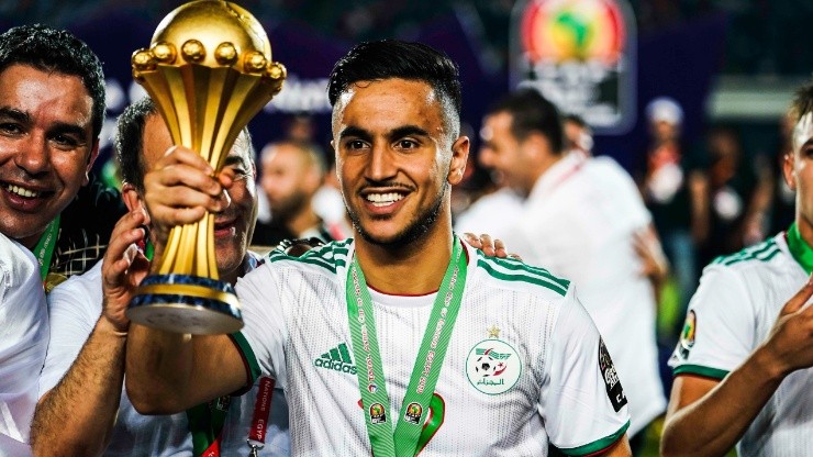 Adam Ounas of Algeria celebrates with the 2019 Africa Cup of Nations Trophy