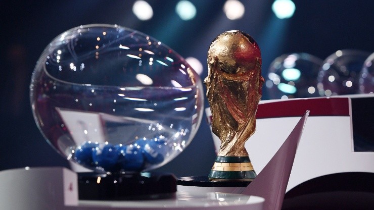 The FIFA World Cup trophy and a draw pot.