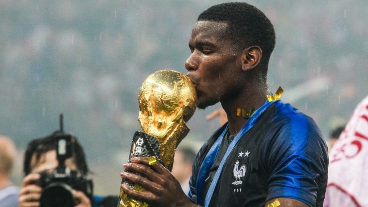 Paul Pogba kisses the FIFA World Cup Trophy he won with France in Russia 2018