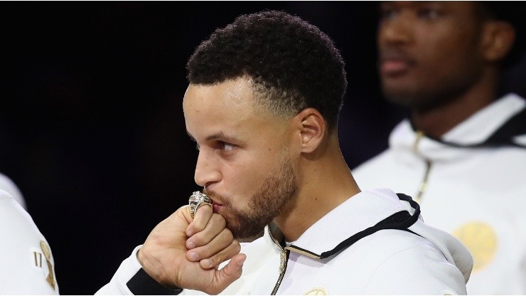 Stephen Curry of the Golden State Warriors kisses his NBA Championship ring
