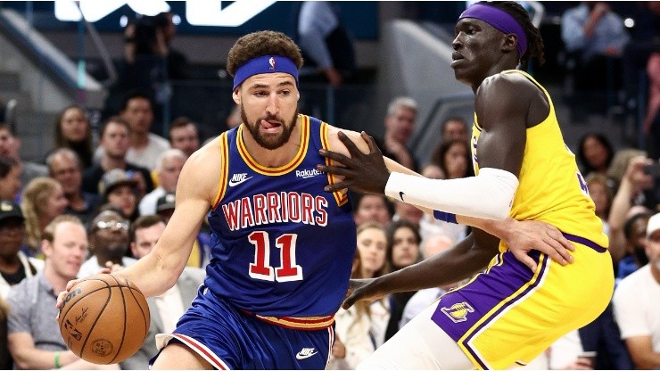 Klay Thompson of the Golden State Warriors is guarded by Wenyen Gabriel of the Los Angeles Lakers