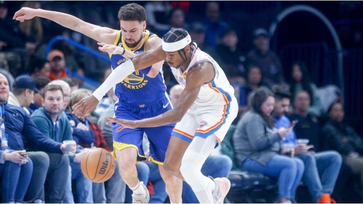 Shai Gilgeous-Alexander #2 of the Oklahoma City Thunder steals the ball from Klay Thompson #11 of the Golden State Warriors