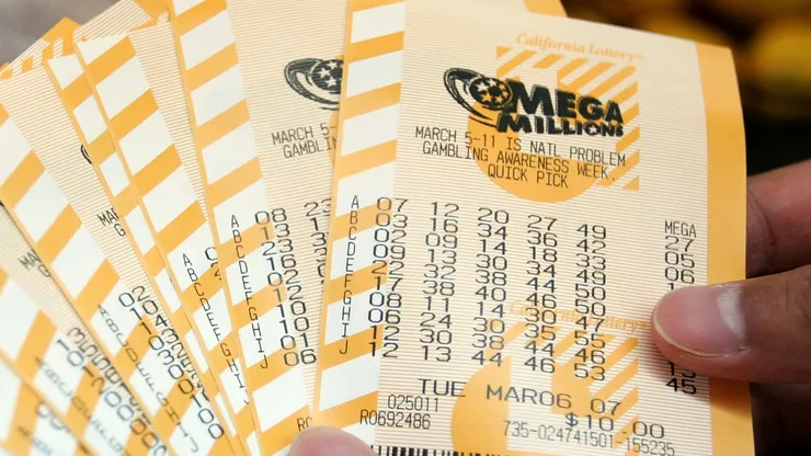 A man holds a bundle of Mega Millions lottery tickets