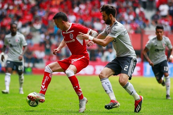 Pareja en uno de sus pocos partidos con Atlas. (Getty)