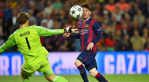 Messi chips Neuer as he scores in the game (Getty).