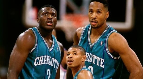 Muggsy Bogues (the shortest player in NBA history), Larry Johnson, & Alonzo Mourning. (Getty)