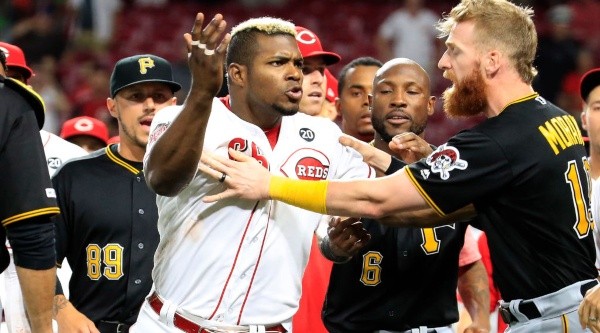 Yasiel Puig (Reds) being held back after a brawl with the Pirates. (Getty)