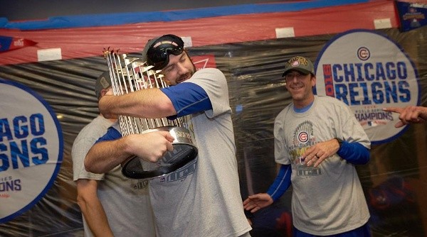 Chicago Cubs Jason Hammel hugging the World Series trophy in locker room after winning the series vs Cleveland Indians. (Getty)