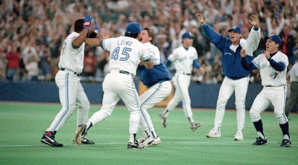 Joe Carter of the Toronto Blue Jays celebrating with his teammates. (Getty)