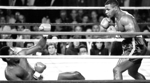 Mike Tyson (right) knocks down Robert Colay (Getty).