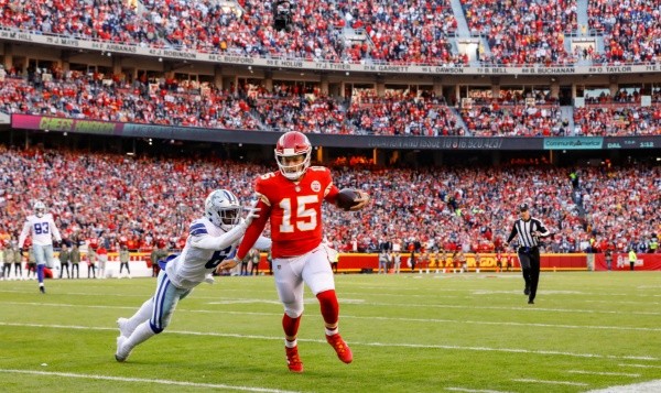 Patrick Mahomes #15 of the Kansas City Chiefs runs towards the sidelines in the first quarter, pursued by Donovan Wilson #6 of the Dallas Cowboys at Arrowhead Stadium on November 21, 2021 in Kansas City, Missouri. (Photo by David Eulitt/Getty Images)
