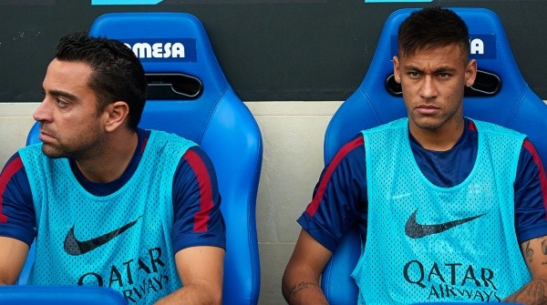 2014 | Neymar Jr and Xavi of Barcelona sit on the bench / Manuel Queimadelos Alonso/Getty Images