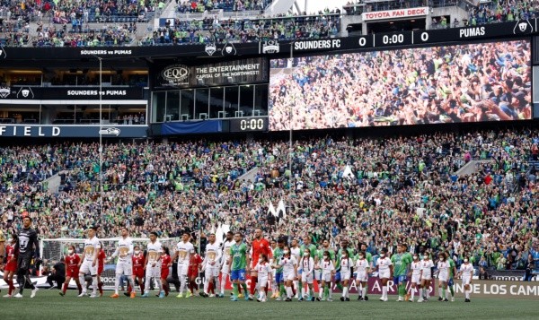 SEATTLE, WASHINGTON - MAY 04: Players of the Seattle Sounders and Pumas make their way to center field during 2022 Scotiabank Concacaf Champions League Final Leg 2 at Lumen Field on May 04, 2022 in Seattle, Washington. (Photo by Steph Chambers/Getty Images)